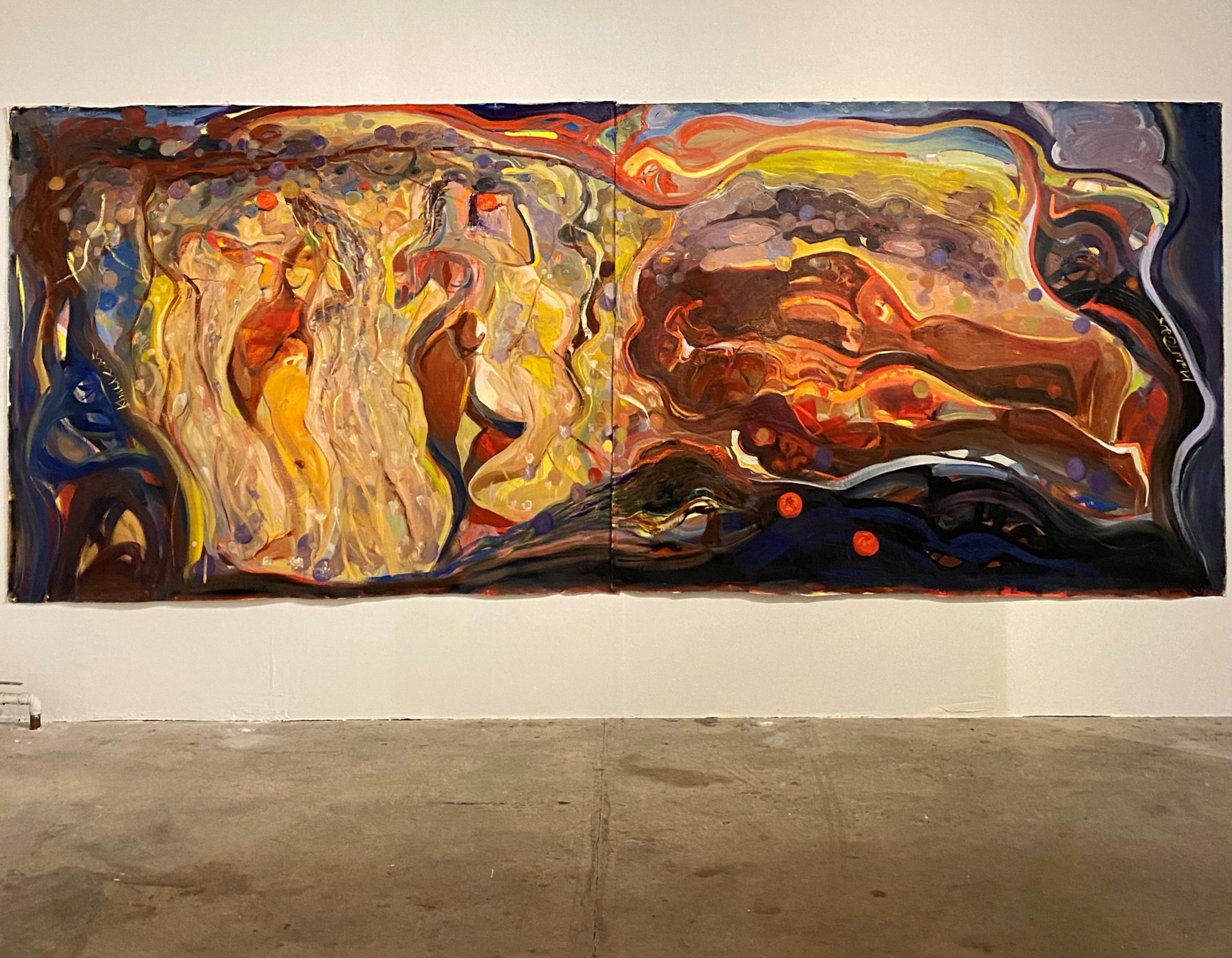 A large abstract painting with swirling, flowing shapes and vibrant colors, including yellows, reds, blues, and browns, displayed on a white gallery wall with a concrete floor beneath.