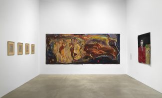 A gallery room displays five framed drawings on the left wall, a large colorful abstract painting on the center wall, and a smaller figurative painting with two faces on the right wall. The gallery has white walls and a concrete floor.