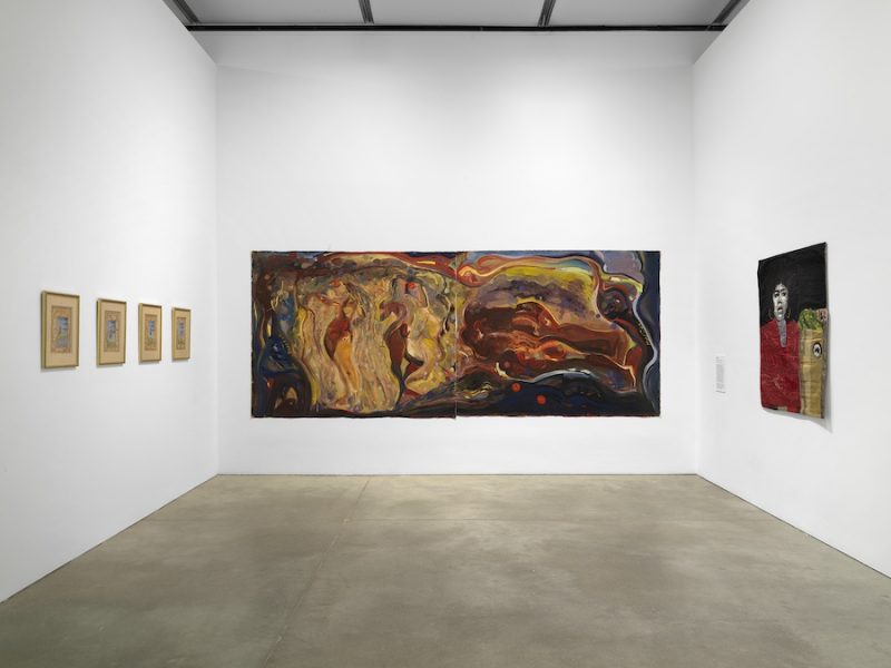 A gallery room displays five framed drawings on the left wall, a large colorful abstract painting on the center wall, and a smaller figurative painting with two faces on the right wall. The gallery has white walls and a concrete floor.