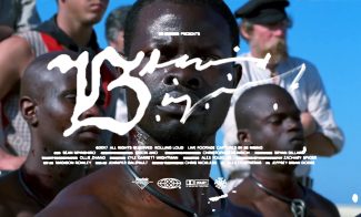 A close-up of a man with sweat on his face, standing among a group of people under bright sunlight. White handwritten text and film credits are overlaid across the image.