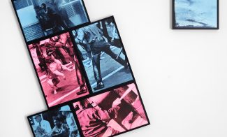 Four framed prints in blue and pink tones featuring people in motion are arranged in a staggered cluster on a white wall, with a fifth smaller print of a running figure hung separately to the right.