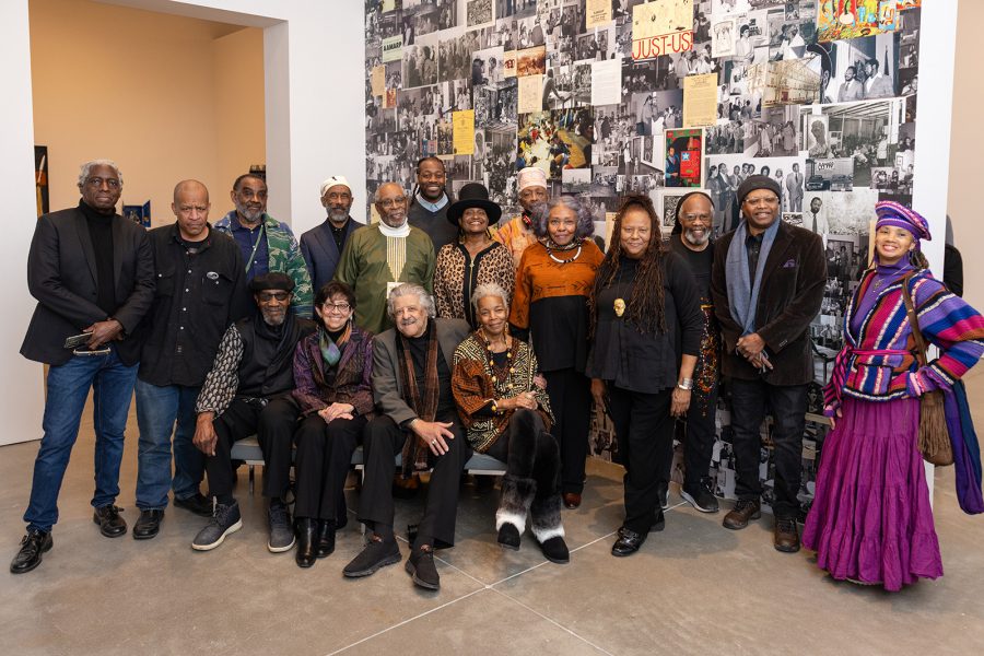 Current and former AAMARP artists posing for a group photo in the Say It Loud: AAMARP, 1977 to Now gallery space.