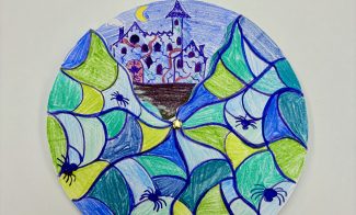 A circular drawing of a spooky castle behind a spiderweb pattern, decorated with several black spiders and a crescent moon.
